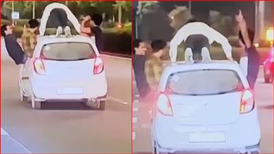 An inebriated youth did pushups on the roof of the car, finished it and started dancing, 2 boys hanging in the windows